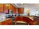 Well-equipped kitchen featuring cherry cabinets, granite countertops, and stainless steel appliances at 3308 Purple Martin Dr # 121, Punta Gorda, FL 33950