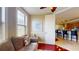 Relaxing living room has a comfy sofa, window with blinds, and is located next to the kitchen at 3308 Purple Martin Dr # 121, Punta Gorda, FL 33950