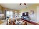 Comfortable living room with a ceiling fan and sliding glass doors leading to a balcony at 3308 Purple Martin Dr # 121, Punta Gorda, FL 33950