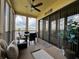 Screened patio has comfortable seating, a ceiling fan, a lake view, and lots of sunshine at 3308 Purple Martin Dr # 121, Punta Gorda, FL 33950