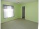 Cozy bedroom features a ceiling fan and plush carpet with a window for natural light at 388 Orlando Blvd, Port Charlotte, FL 33954