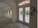 Bright entryway with tile flooring, decorative parrot wall art, and an arched doorway at 388 Orlando Blvd, Port Charlotte, FL 33954