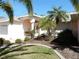Attractive home with a well-maintained lawn, a bench near the front door, and lush tropical landscaping at 388 Orlando Blvd, Port Charlotte, FL 33954