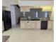 Open kitchen with granite countertops, black appliances, and a view into the living room, perfect for entertaining at 388 Orlando Blvd, Port Charlotte, FL 33954