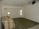 Spacious living room with a ceiling fan, large windows and vaulted ceilings offers comfort and natural light at 388 Orlando Blvd, Port Charlotte, FL 33954