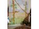 Unique mural of jungle scene on the wall, complete with giraffe and various foliage at 388 Orlando Blvd, Port Charlotte, FL 33954