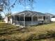 Spacious screened-in patio provides an inviting outdoor living space, with views of a green yard at 388 Orlando Blvd, Port Charlotte, FL 33954