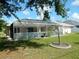 Spacious screened-in patio provides an inviting outdoor living space, with views of a green yard at 388 Orlando Blvd, Port Charlotte, FL 33954