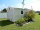 Exterior view of a storage shed with garden bed and a partial view of fencing at 388 Orlando Blvd, Port Charlotte, FL 33954