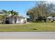 This beautifully landscaped yard features mature trees, a well-maintained lawn, and attractive shrubbery at 388 Orlando Blvd, Port Charlotte, FL 33954