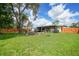 Spacious backyard featuring a lawn and a fire pit area, perfect for outdoor gatherings and relaxation at 4062 Blitzen Ter, North Port, FL 34287