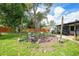 Inviting backyard area with a cozy fire pit, string lights, and comfortable seating, perfect for outdoor entertainment at 4062 Blitzen Ter, North Port, FL 34287