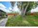 Lush backyard with a mature tree offering shade, plus a fire pit area with seating and a charming garden at 4062 Blitzen Ter, North Port, FL 34287