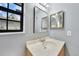 Bathroom featuring a white countertop vanity with framed mirrors and accent lighting at 4062 Blitzen Ter, North Port, FL 34287
