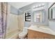 Bathroom showcasing a sink and toilet and a tub/shower behind a curtain at 4062 Blitzen Ter, North Port, FL 34287