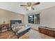 Cozy bedroom with tiled floors, ceiling fan, and a large window allowing natural light at 4062 Blitzen Ter, North Port, FL 34287