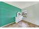 Bedroom showcasing an accent wall and white dresser with a large mirror at 4062 Blitzen Ter, North Port, FL 34287