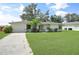 Well-maintained home with a lush green lawn, inviting curb appeal, and a convenient attached garage at 4062 Blitzen Ter, North Port, FL 34287