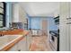 A well-organized kitchen featuring stainless appliances, butcher block countertop and colorful backsplash at 4062 Blitzen Ter, North Port, FL 34287
