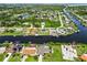 Aerial view of waterfront homes with docks on a scenic canal, ideal for boating and enjoying the water at 4123 Rock Creek Dr, Port Charlotte, FL 33948