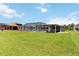 Expansive backyard with green grass, a screened-in pool, and plenty of room for outdoor activities and relaxation at 4123 Rock Creek Dr, Port Charlotte, FL 33948