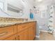 Bright bathroom featuring a granite vanity top and whimsical shower curtain at 4123 Rock Creek Dr, Port Charlotte, FL 33948