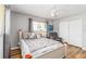 Bright bedroom with a ceiling fan, plush chair, wood-look floors and closet at 4123 Rock Creek Dr, Port Charlotte, FL 33948