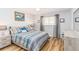 Cozy bedroom with stylish blue and grey bedding, wood-look floors and ceiling fan at 4123 Rock Creek Dr, Port Charlotte, FL 33948