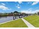 Picturesque canal-front property featuring a boat dock with a green metal roof and lush green grass at 4123 Rock Creek Dr, Port Charlotte, FL 33948