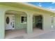 Charming front entrance features arched columns, a white front door, and a cozy seating area at 4123 Rock Creek Dr, Port Charlotte, FL 33948