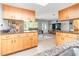 Spacious kitchen with a view to the living area, featuring light wood cabinetry and tile flooring at 4123 Rock Creek Dr, Port Charlotte, FL 33948