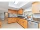 Well-lit kitchen featuring granite counters, wood cabinets, and stainless steel appliances at 4123 Rock Creek Dr, Port Charlotte, FL 33948