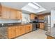Updated kitchen with stainless appliances, tile floors, and granite countertops at 4123 Rock Creek Dr, Port Charlotte, FL 33948