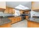 Modern kitchen with stainless steel appliances and wooden cabinets illuminated by a skylight at 4123 Rock Creek Dr, Port Charlotte, FL 33948