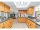 Bright kitchen with granite countertops, stainless steel appliances, and a skylight at 4123 Rock Creek Dr, Port Charlotte, FL 33948