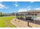 Covered patio area with seating, overlooking the pool and canal, perfect for outdoor relaxation and entertaining at 4123 Rock Creek Dr, Port Charlotte, FL 33948