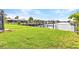 Spacious grass backyard featuring a canal view at 4244 Harbor Blvd, Port Charlotte, FL 33952