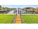 Fenced backyard with a walkway leading to the boat dock at 4244 Harbor Blvd, Port Charlotte, FL 33952