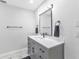 Bathroom featuring a gray vanity with a white countertop, modern fixtures, and a marble-tiled floor at 4244 Harbor Blvd, Port Charlotte, FL 33952