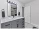 Bathroom featuring a sleek vanity with modern lighting, fixtures, and a view of a tiled shower at 4244 Harbor Blvd, Port Charlotte, FL 33952