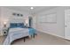 Bright bedroom featuring soft lighting, a ceiling fan, a queen bed and blue bedding at 4244 Harbor Blvd, Port Charlotte, FL 33952