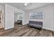 Bedroom with a sliding mirror door closet, hardwood floors, and a gray futon-style couch at 4244 Harbor Blvd, Port Charlotte, FL 33952