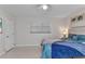 Bright bedroom featuring a ceiling fan, window, and a bed with unique ocean-themed bedding at 4244 Harbor Blvd, Port Charlotte, FL 33952