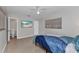 Bedroom with a television, ceiling fan, window, and a bed featuring unique ocean-themed bedding at 4244 Harbor Blvd, Port Charlotte, FL 33952