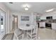 Bright dining area with a white round table, seating for four, and views of the renovated white kitchen at 4244 Harbor Blvd, Port Charlotte, FL 33952