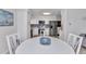 Cozy dining area with a round table and a view of the adjacent, remodeled kitchen at 4244 Harbor Blvd, Port Charlotte, FL 33952