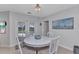 Charming dining area featuring a round white table and a view of the pool area through glass doors at 4244 Harbor Blvd, Port Charlotte, FL 33952