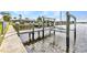 Waterfront dock with a boat lift providing easy access to boating and water activities at 4244 Harbor Blvd, Port Charlotte, FL 33952