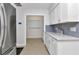 Updated kitchen featuring white cabinets, modern countertops, and stainless steel appliances at 4244 Harbor Blvd, Port Charlotte, FL 33952