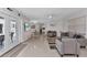 Spacious living room with a ceiling fan, recessed lights, contemporary furnishings, and polished floors at 4244 Harbor Blvd, Port Charlotte, FL 33952